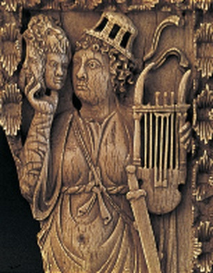 Stone relief of an actor holding a mask and a lyre.